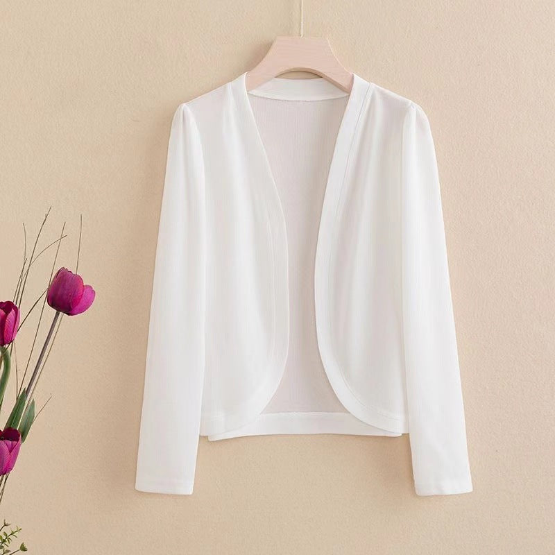 Authentic Shopify product photograph of a short solid-color women's shawl cardigan, shown in a fall layering outfit guide