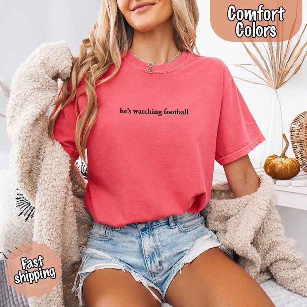 He’s Watching Football Tee - Comfort Colors Funny Shirt for Her