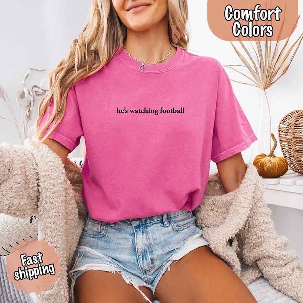 He’s Watching Football Tee - Comfort Colors Funny Shirt for Her