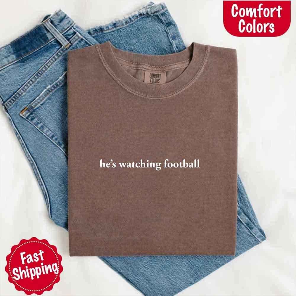 He’s Watching Football Tee - Comfort Colors Funny Shirt for Her