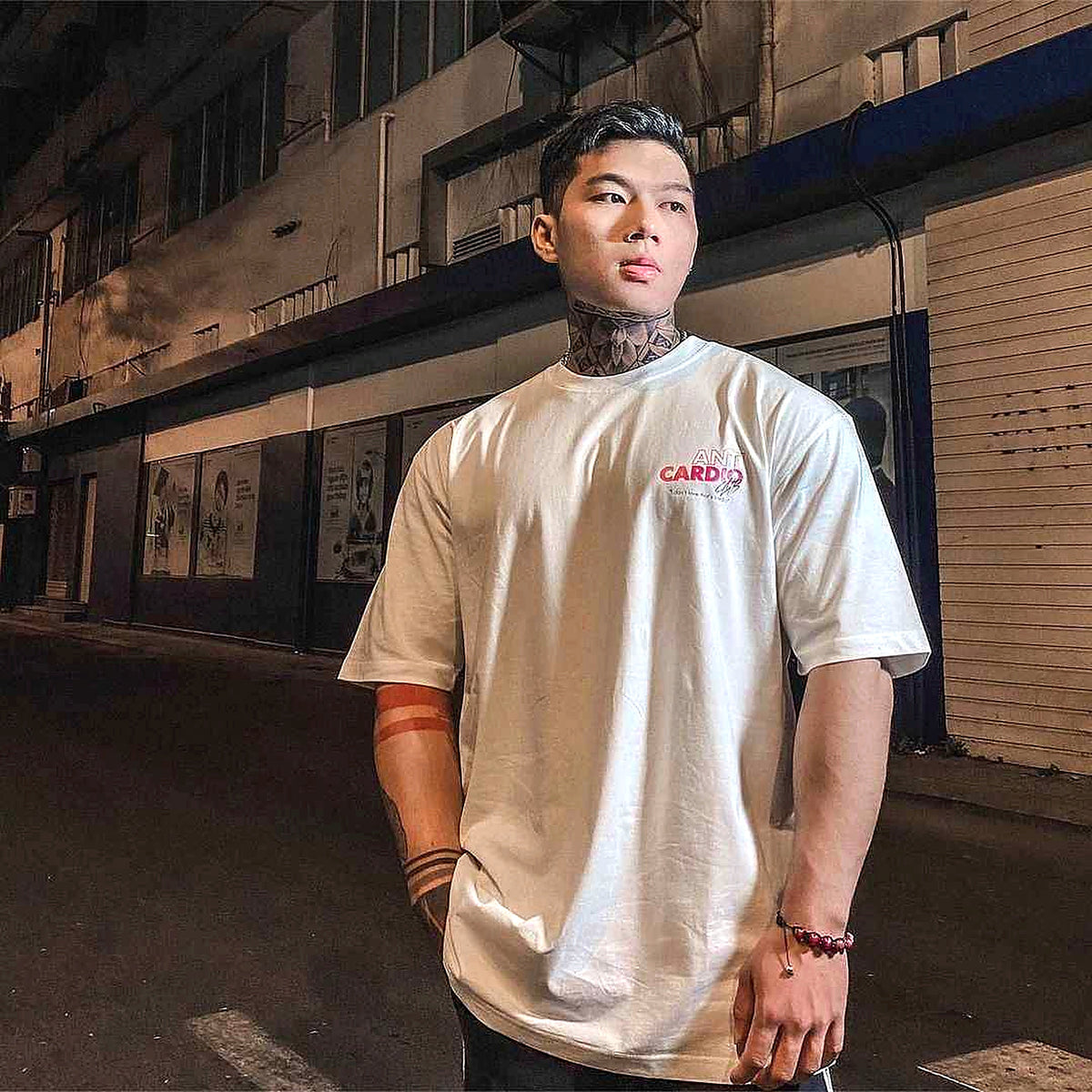 White Anti Cardio graphic T-shirt worn outdoors, authentic premium-enhanced photograph