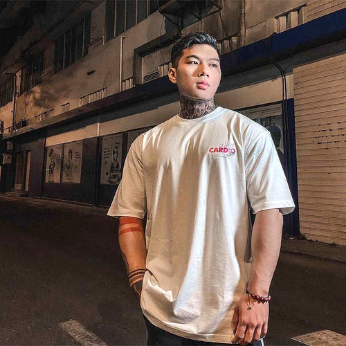 White Anti Cardio graphic T-shirt worn outdoors, authentic premium-enhanced photograph