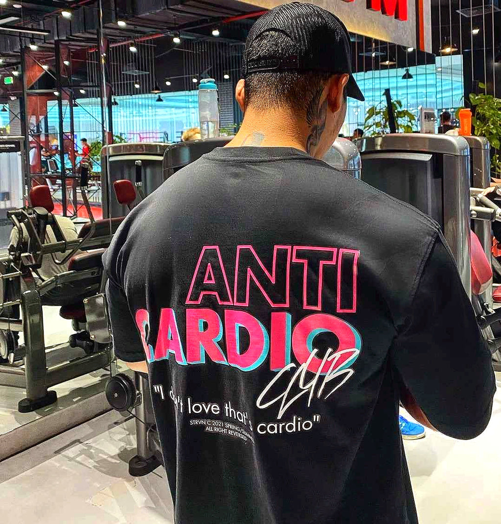 Black Anti Cardio gym T-shirt back print worn by model near equipment