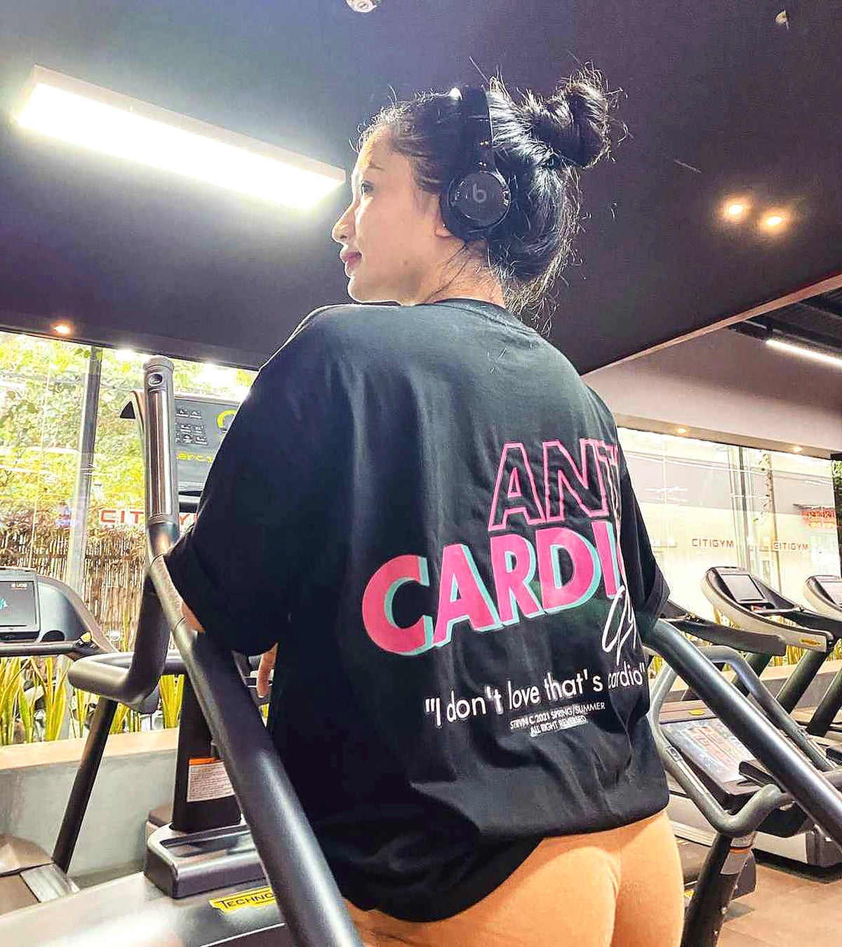 Black Anti Cardio tee original back graphic in gym lifestyle photo